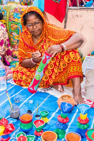Indian woman making handicraft items