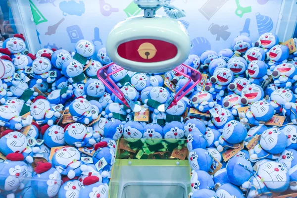 Doraemon dolls in toy crane machine.