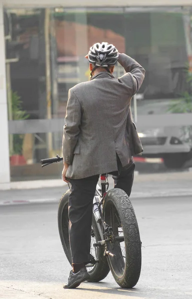 man in a business on bike