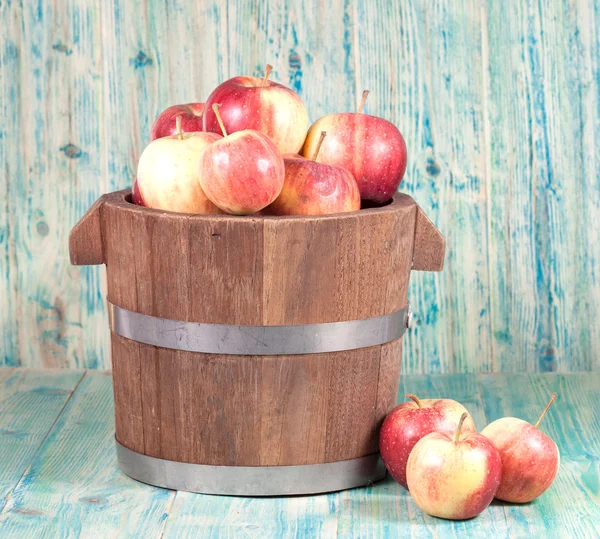 Red apples in wooden bucket