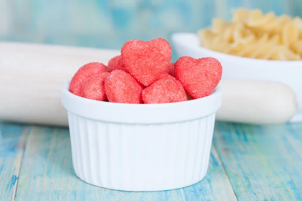 Heart candies coated with sugar in white cup.selective focus.