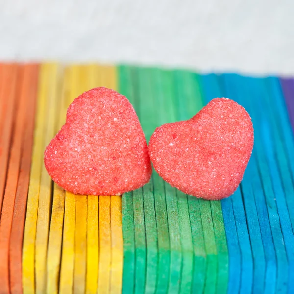 Heart candies coated with sugar sitting on color