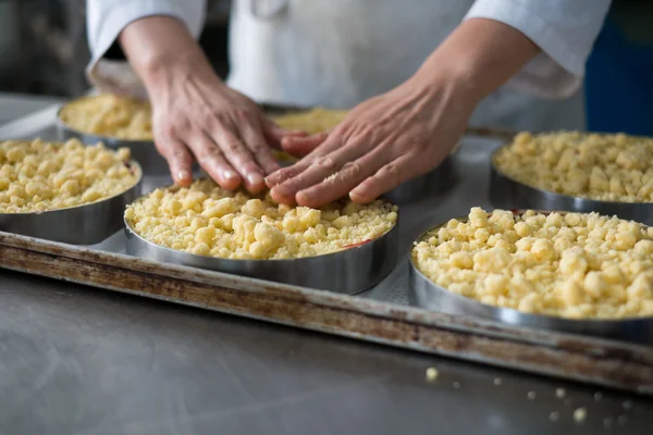 Chef Topping Cheese Cakes in Bakery