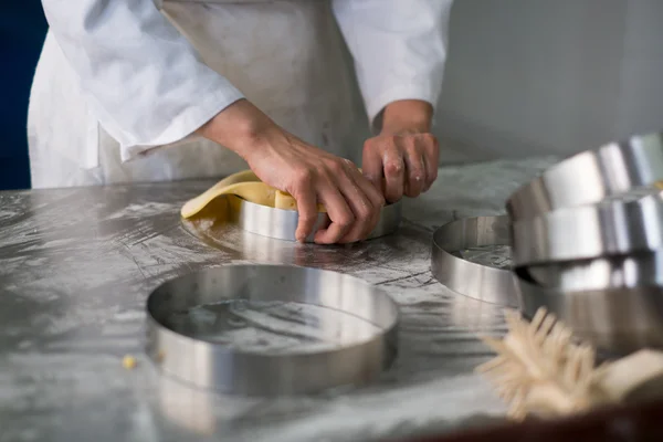 Pastry Chefs Hands Puling Pie Dough