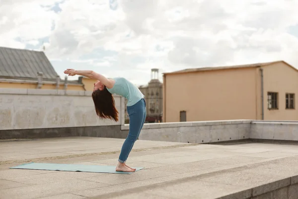 Young woman in a yoga back bend pose