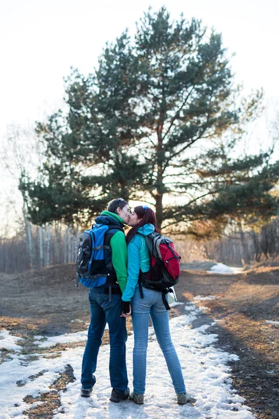 Hiking couple in spring forest.