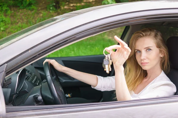 Young woman showing car key