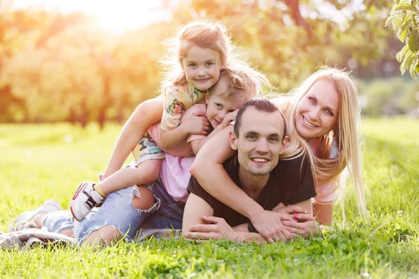 Family playing in the park on the grass