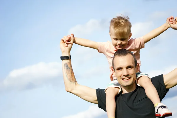 Son on the shoulders of his father