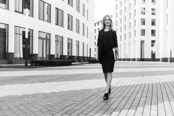 Black-and-white portrait of stylish successful business woman