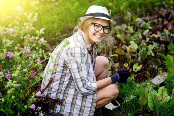 Portrait of stylish country woman working in garden