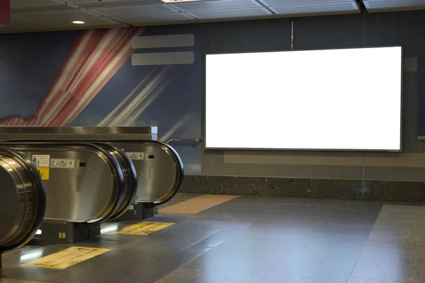 Blank bill board for advertising in front of escalator