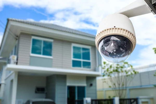CCTV Camera or surveillance operating with house village in back