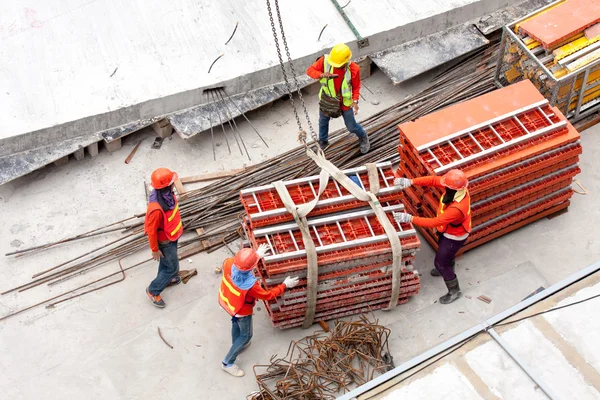 Construction workers working in site lifting tools