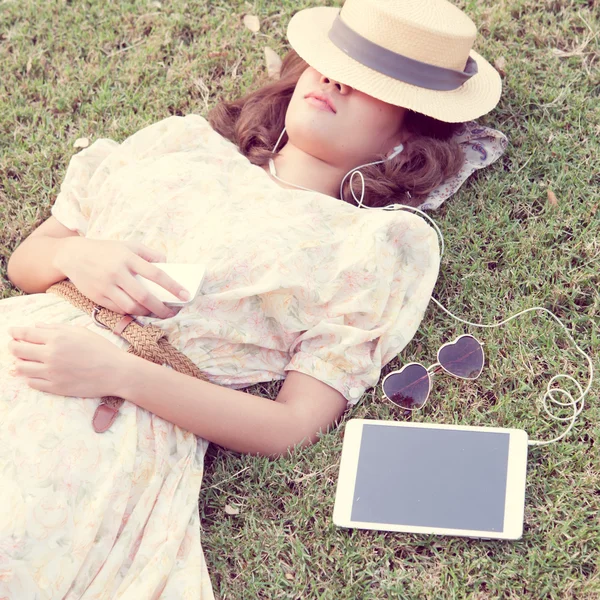 Vintage Girl sleep in park listen music via small talk