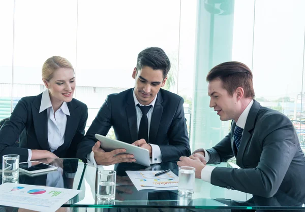 Business partners discussing documents and ideas at meeting