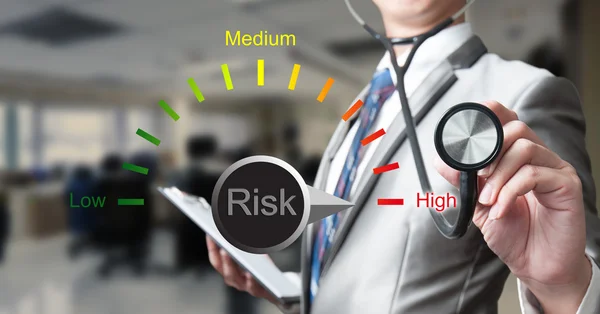 Business man with stethoscope, risk management concept