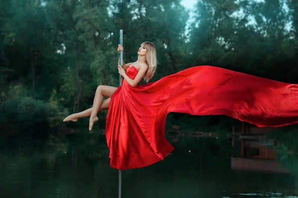 Girl dancing on a pole and her dress develops.