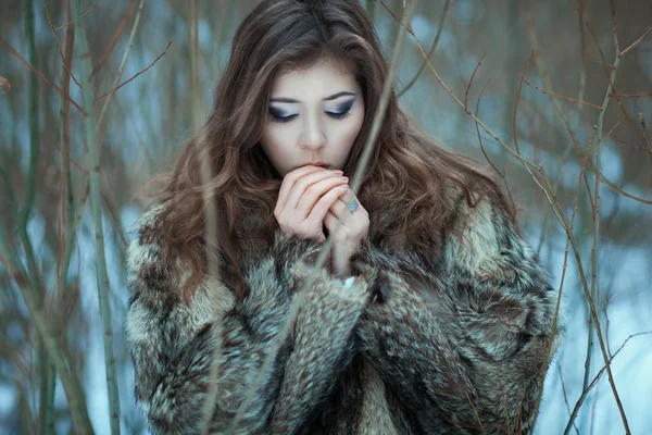 Girl breathes in the cold hands.