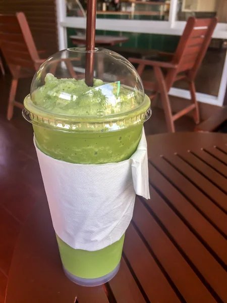 Smoothies milk green tea with a straw