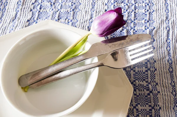 A dinner plate, knife and fork