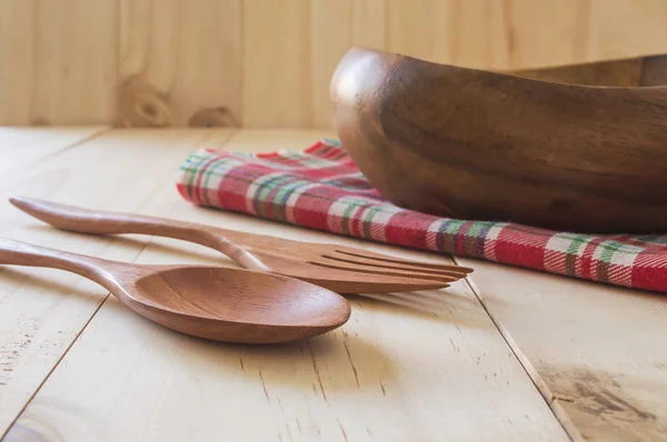 Close up wood spoon with fork and wood bowl isolated on wood bac