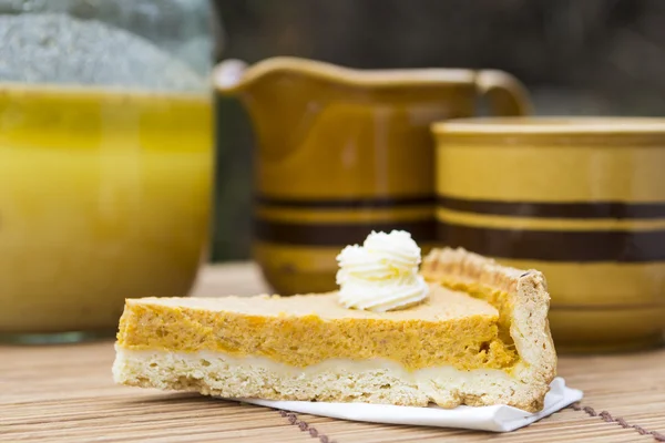 Sweet pumpkin pie with cream close up