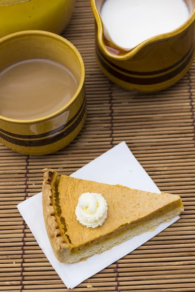 Sweet pumpkin pie with cream close up