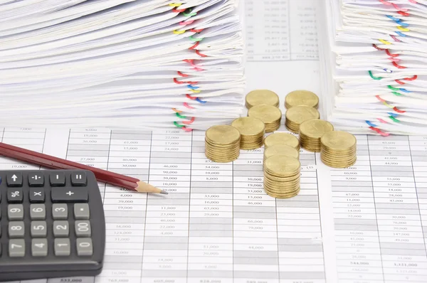 Step pile of gold coins and pencil with dual document