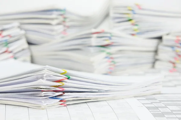 Pile paperwork of report with colorful paperclip on finance account
