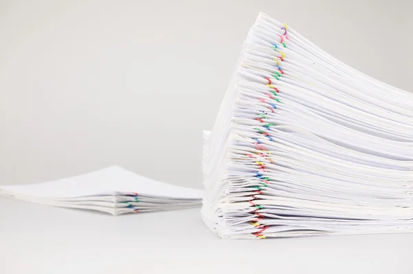 Pile overload paperwork with colorful paperclip with blur pile document