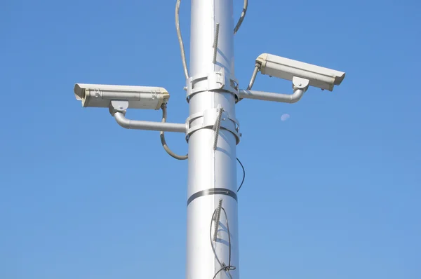 Security camera on high pole with blue sky