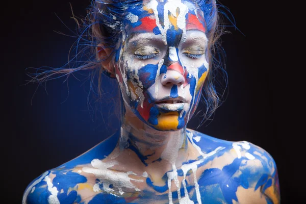Face of a woman covered with paint