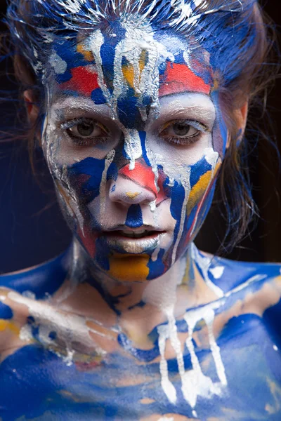 Face of a woman covered with paint