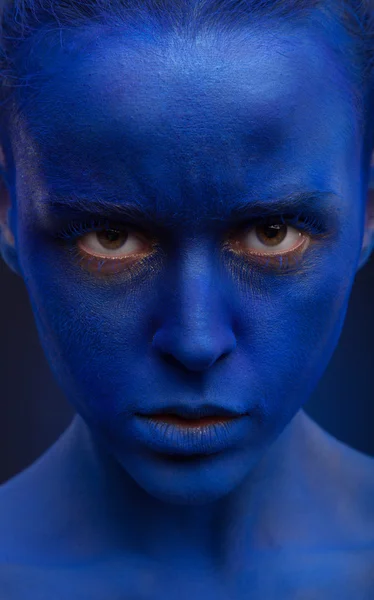 Woman with creative blue face art