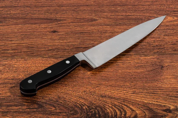 Kitchen knife on a wooden table