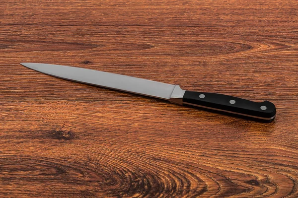 Kitchen knife on a wooden table