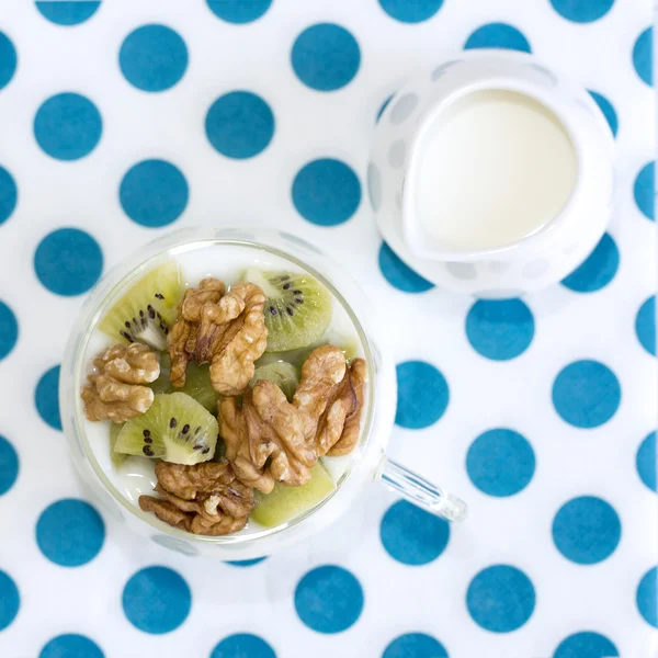 Plain yogurt with kiwi and nuts with milk jug