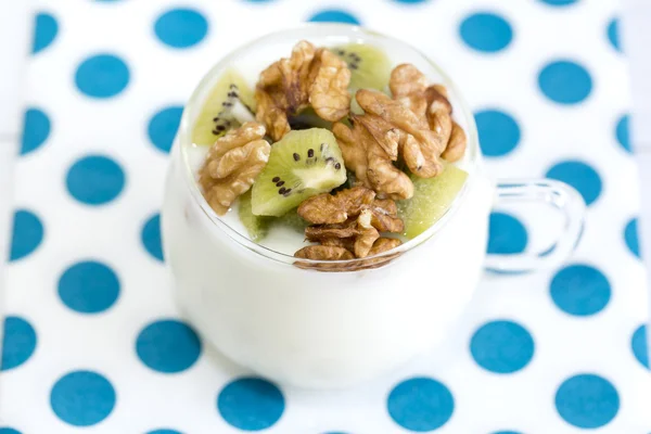 Glass with Plain yogurt with kiwi and nuts