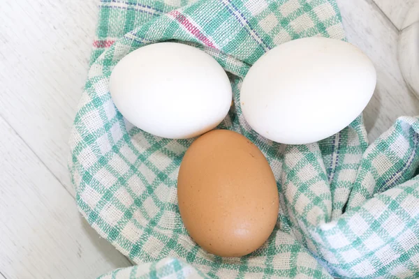 Group of three eggs on colored cloth