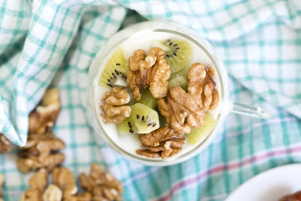 Glass with Plain yogurt with kiwi and nuts