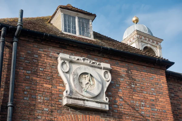 Old sundial on a building in Rye East Sussex