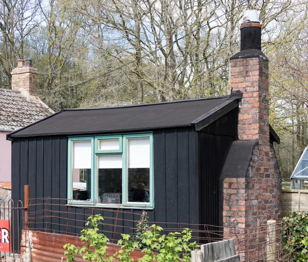 Small black living shed at St Fagans National History Museum in