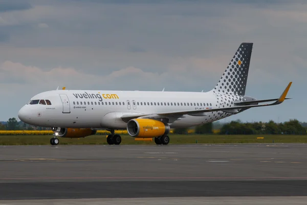 PRAGUE, CZECH REPUBLIC - MAY 15: A320 Vueling taxis to terminal at PRG Airport on May 15 2015. Vueling is a spanish low-cost airline with 15 million passengers in 2012