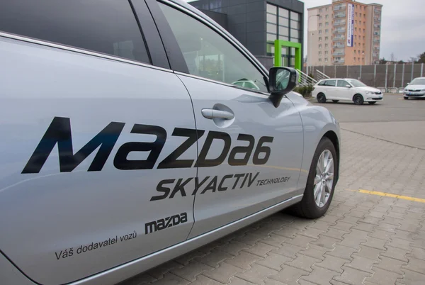 Mazda in front of car store Mazda