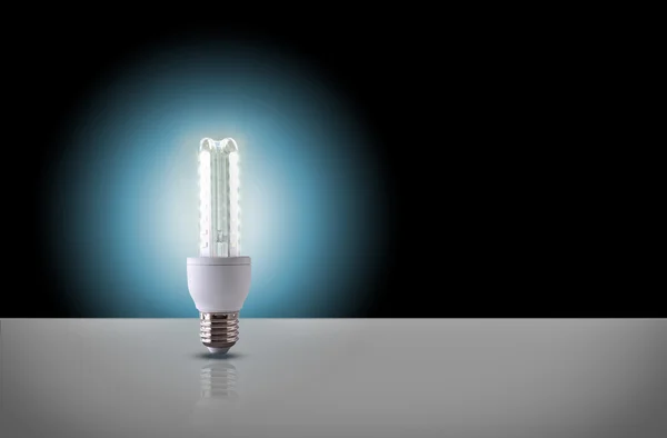 One led light bulb on black background