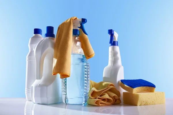 Cleaning products and equipment on white table overview