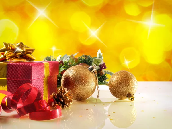 Yellow Christmas decoration with two balls and gift Horizontal c