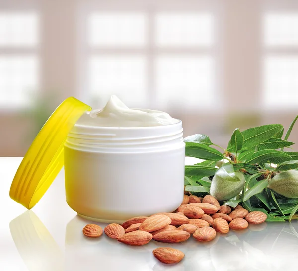 Almond moisturizer cream jar open windows background square comp