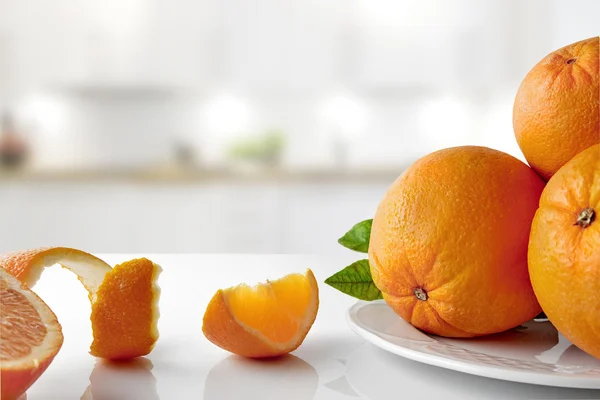 Group of oranges on a plate and sections horizontal composition